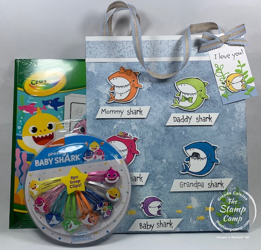 How would you like to create a Baby Shark Gift Bag and Tag to match the gift that is inside? Well today I have just that project for you with this bag and tag featuring the Shark Frenzy stamp set from Stampin' Up! Inside the fun bag is a Baby Shark Coloring Book and Baby Shark Hair clips. #thestampcamp #stampinup #babyshark